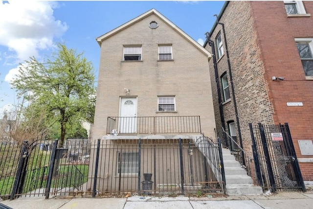 2629 W Luther St, Chicago, IL 60608 - rear view of property with brick siding, a gate, and a fenced front yard