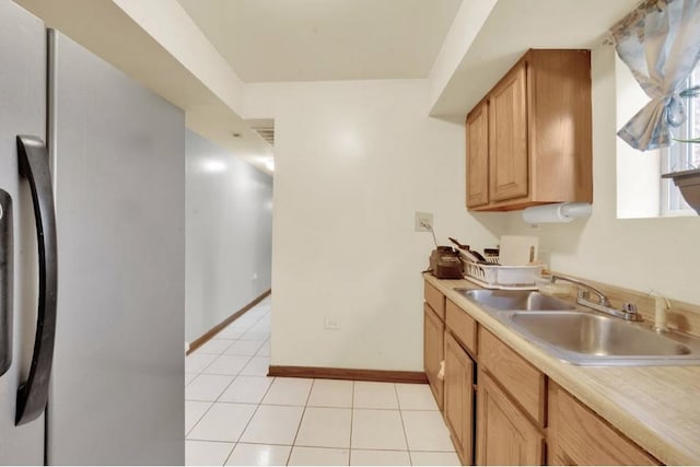 2629 W Luther St, Chicago, IL 60608 - kitchen featuring a sink, light tile patterned flooring, freestanding refrigerator, baseboards, and light countertops