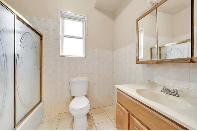 2629 W Luther St, Chicago, IL 60608 - bathroom featuring a wainscoted wall, toilet, tile walls, tile patterned flooring, and vanity