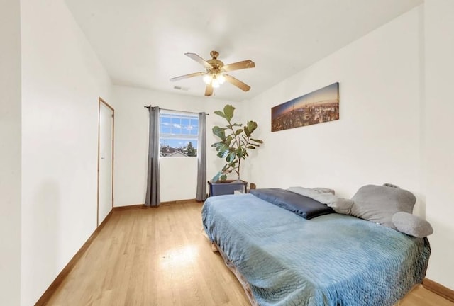 2629 W Luther St, Chicago, IL 60608 - bedroom with a ceiling fan, baseboards, and light wood-style floors