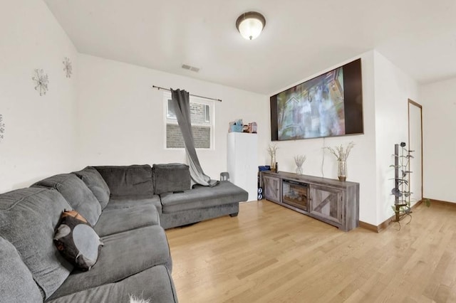 2629 W Luther St, Chicago, IL 60608 - living room with wood finished floors, visible vents, and baseboards