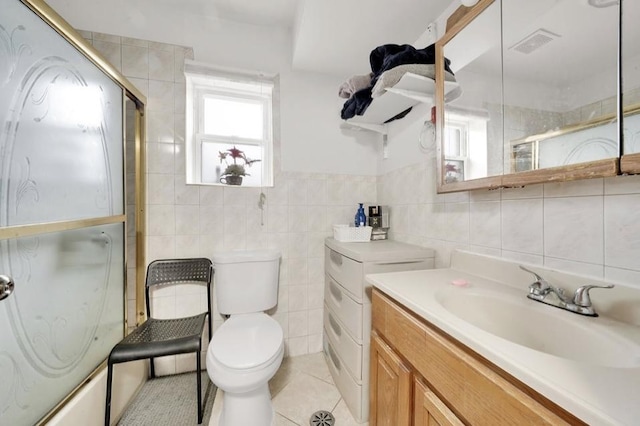 2629 W Luther St, Chicago, IL 60608 - bathroom featuring tile patterned floors, toilet, tile walls, visible vents, and vanity