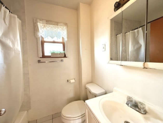 2919 S Quinn St, Chicago, IL 60608 - bathroom with tile patterned flooring, toilet, and vanity