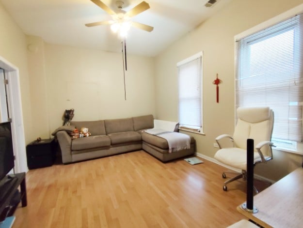 2919 S Quinn St, Chicago, IL 60608 - living area featuring light wood finished floors and ceiling fan