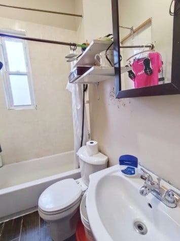 2919 S Quinn St, Chicago, IL 60608 - full bathroom featuring shower / bath combination with curtain, toilet, and a sink