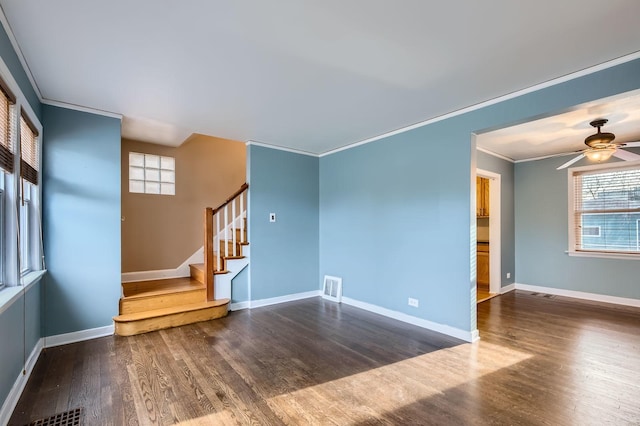 unfurnished living room featuring stairway, crown molding, wood finished floors, ceiling fan, and visible vents