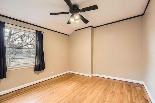 empty room with hardwood / wood-style flooring, baseboards, a ceiling fan, and crown molding