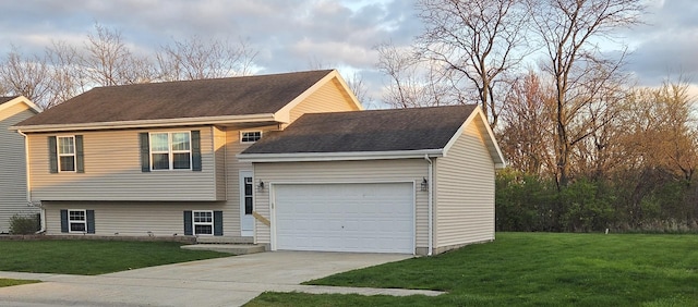 tri-level home featuring an attached garage, driveway, a front yard, and roof with shingles