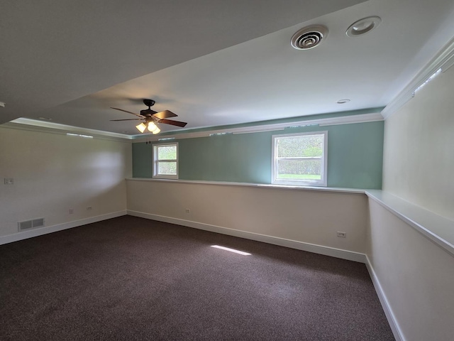 empty room featuring ceiling fan, baseboards, crown molding, and visible vents