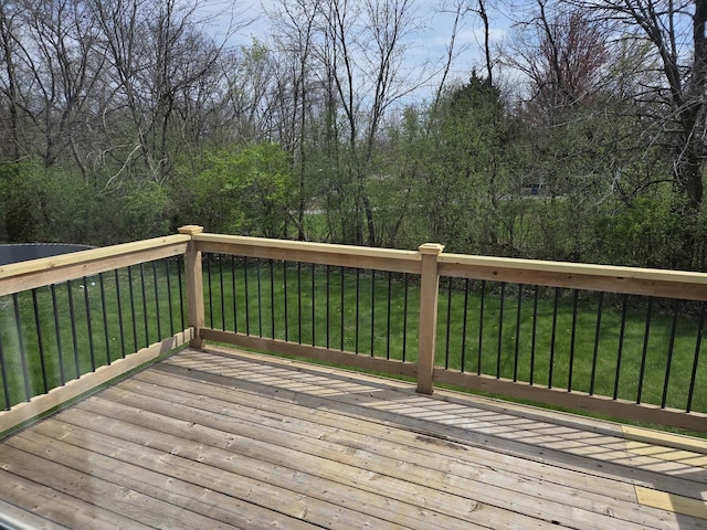 wooden terrace with a lawn