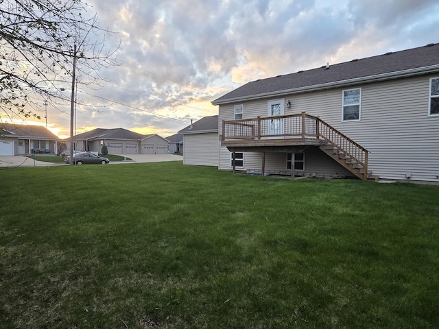 back of house featuring a wooden deck, a lawn, and stairway