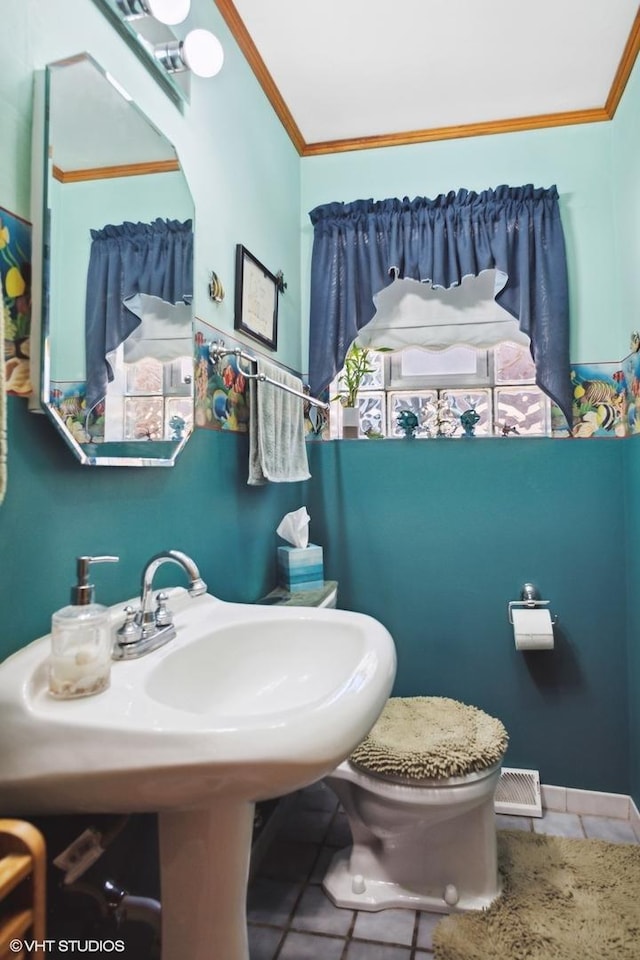 7046 W 63rd Pl, Chicago, IL 60638 - half bathroom with tile patterned floors, toilet, and crown molding
