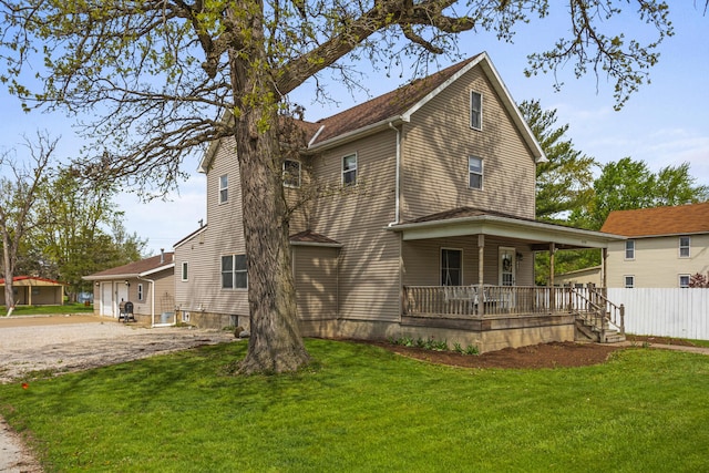 exterior space with a lawn, fence, and a porch
