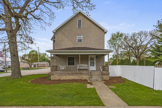 view of front of home featuring a porch, a front lawn, and fence