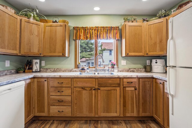 kitchen featuring a sink, white appliances, light countertops, recessed lighting, and dark wood-style floors