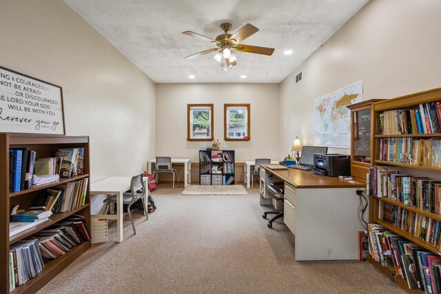 carpeted office space with a ceiling fan and visible vents
