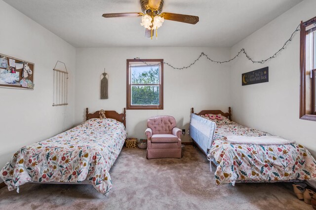 carpeted bedroom with ceiling fan
