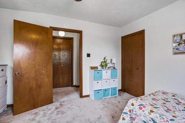 bedroom with carpet floors and baseboards