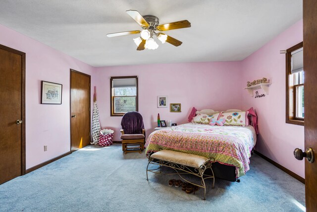 carpeted bedroom featuring a ceiling fan and baseboards