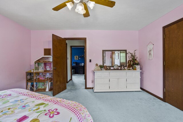 carpeted bedroom with baseboards and ceiling fan