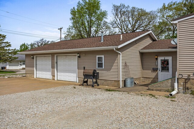 exterior space featuring roof with shingles
