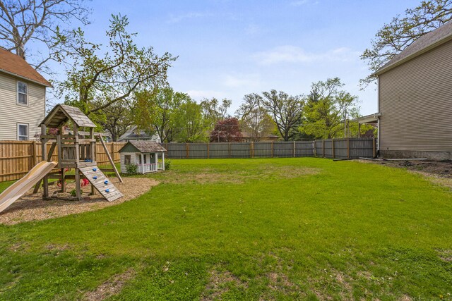 view of yard featuring a fenced backyard and a playground