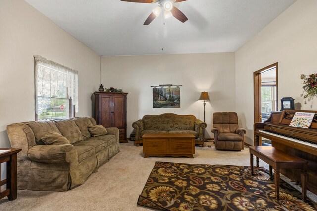 living area with light carpet and a ceiling fan