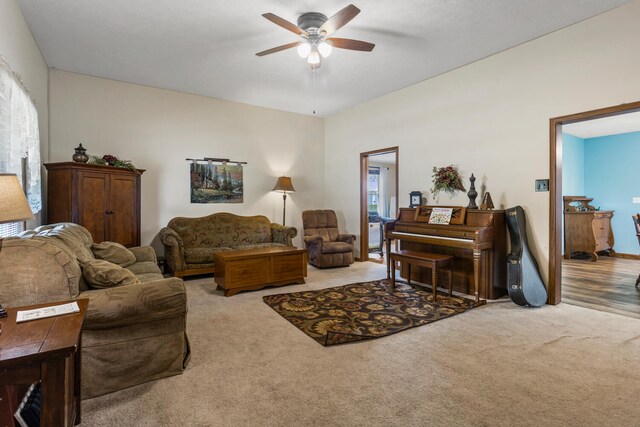 living room featuring carpet floors and a ceiling fan