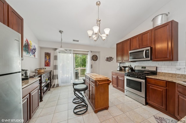 1952 Crenshaw Cir Unit 1952, Vernon Hills, IL 60061 - kitchen with stainless steel appliances, lofted ceiling, tasteful backsplash, hanging light fixtures, and a chandelier