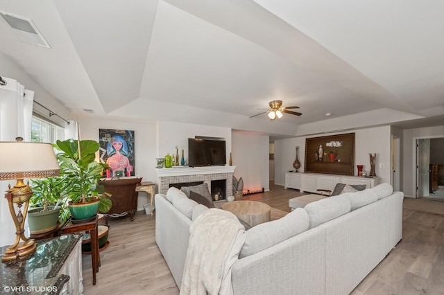 1952 Crenshaw Cir Unit 1952, Vernon Hills, IL 60061 - living area featuring a raised ceiling, ceiling fan, light wood-style flooring, and a fireplace