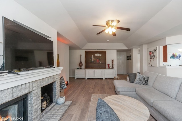1952 Crenshaw Cir Unit 1952, Vernon Hills, IL 60061 - living area with a ceiling fan, a brick fireplace, wood finished floors, and a tray ceiling