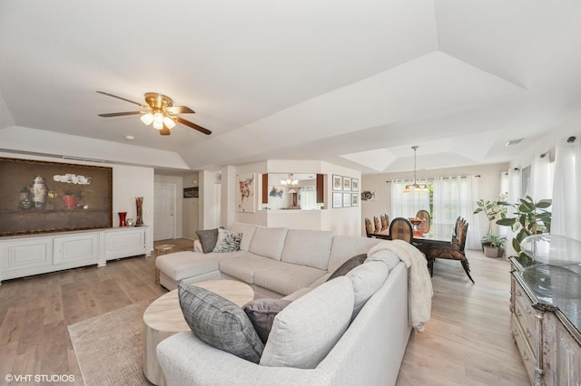 1952 Crenshaw Cir Unit 1952, Vernon Hills, IL 60061 - living area featuring a chandelier, a tray ceiling, light wood finished floors, and a ceiling fan