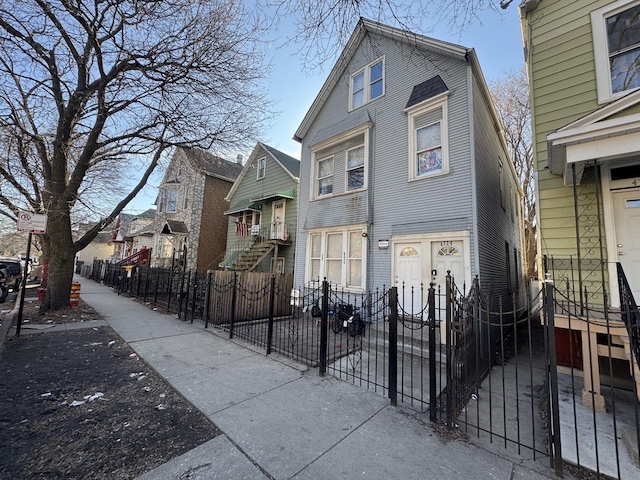 view of front of house featuring a gate, a residential view, and a fenced front yard
