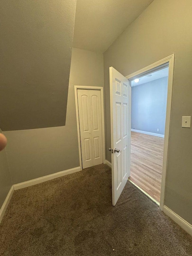 hall featuring baseboards and carpet