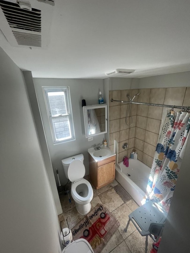 bathroom with shower / bath combination with curtain, tile patterned flooring, vanity, and toilet