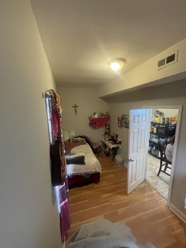 bedroom featuring visible vents and light wood-type flooring