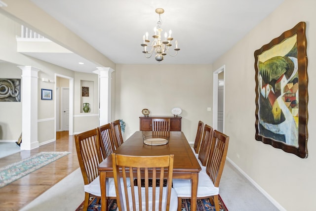 dining area with recessed lighting, baseboards, a notable chandelier, and ornate columns