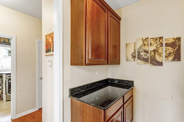 interior space featuring light wood-type flooring and baseboards