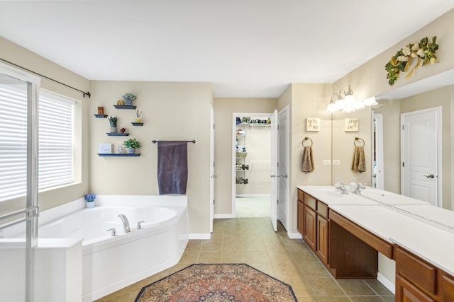 full bathroom with a bath, baseboards, tile patterned flooring, and vanity