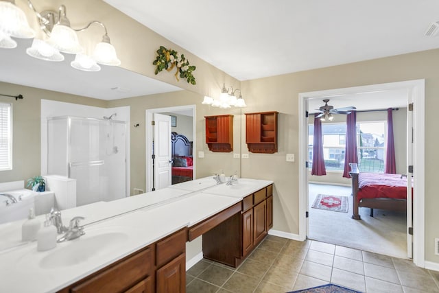 full bathroom with connected bathroom, a shower stall, tile patterned floors, and a sink