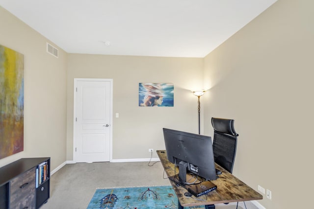 office area featuring baseboards, visible vents, and carpet