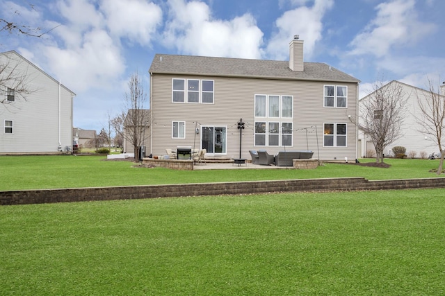 rear view of property with outdoor lounge area, a chimney, entry steps, a yard, and a patio area