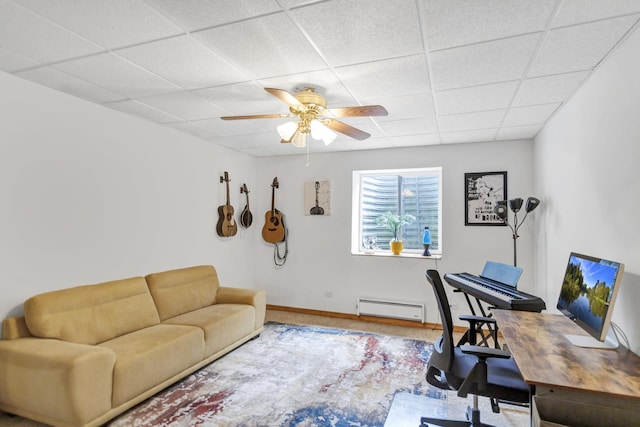 office with a paneled ceiling, baseboards, a baseboard radiator, and a ceiling fan