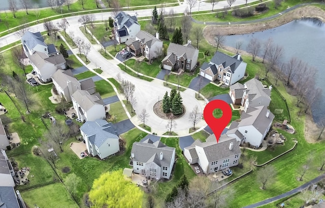 birds eye view of property featuring a residential view and a water view