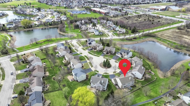 drone / aerial view featuring a residential view and a water view