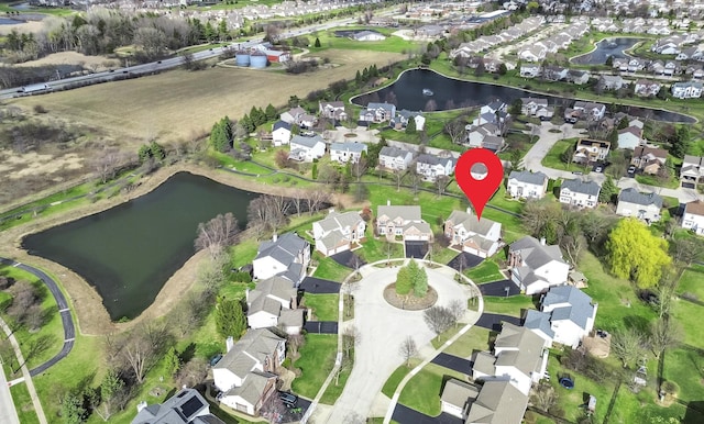 drone / aerial view with a residential view and a water view