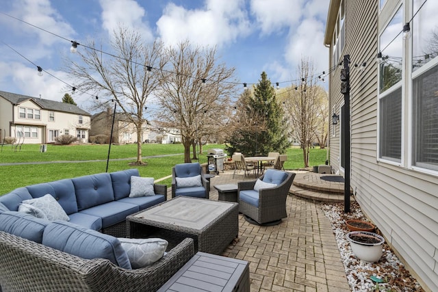 view of patio / terrace with grilling area, an outdoor hangout area, and a residential view