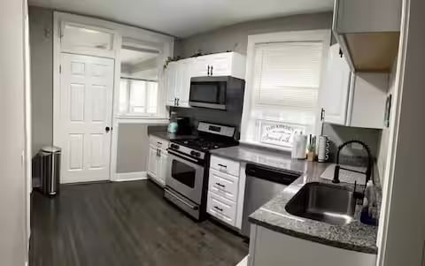 5413 N Artesian Ave, Chicago, IL 60625 - kitchen featuring appliances with stainless steel finishes, white cabinets, and dark wood-style flooring