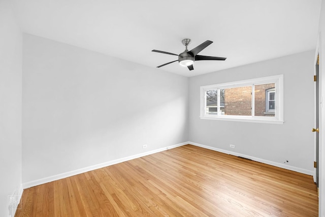 unfurnished room featuring light wood-type flooring, a ceiling fan, and baseboards