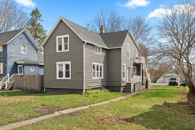 3015 Emmaus Ave, Zion, IL 60099 - back of house featuring a lawn, a shingled roof, and a chimney